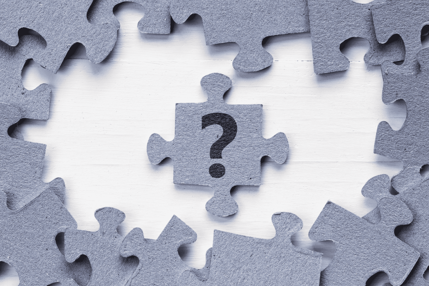 Puzzle pieces surrounding a grey puzzle piece with a question mark on it Puzzle pieces surrounding a grey puzzle piece with a question mark on it